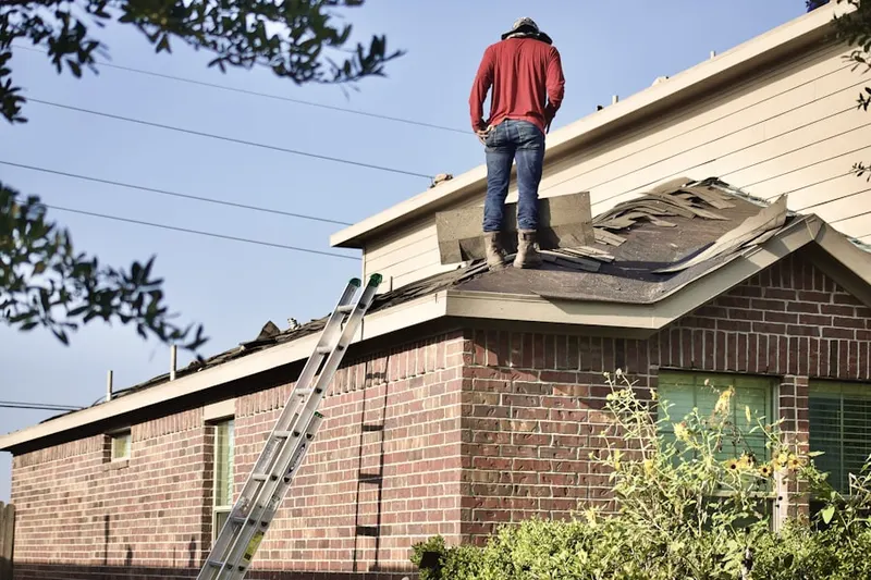Professional roofer working on a residential roof in Harrison Township